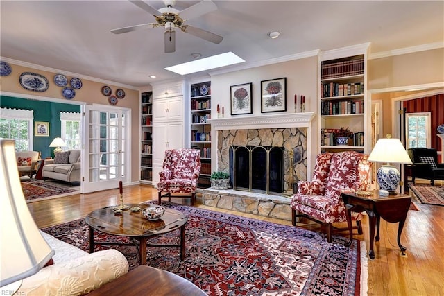 8265 Wrenfield Dr, Williamsburg, VA 23188 - living room with a ceiling fan, crown molding, wood finished floors, and plenty of natural light