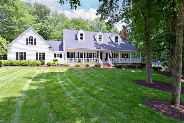 8265 Wrenfield Dr, Williamsburg, VA 23188 - cape cod house featuring a front yard, covered porch, and a chimney