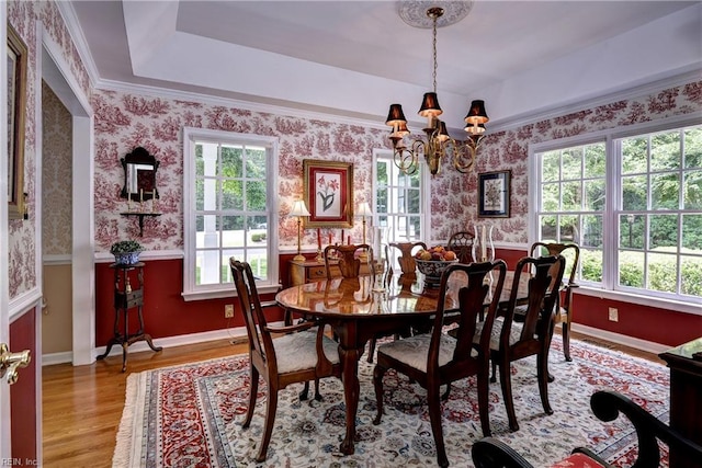 8265 Wrenfield Dr, Williamsburg, VA 23188 - dining area with a chandelier, wood finished floors, wallpapered walls, and a raised ceiling