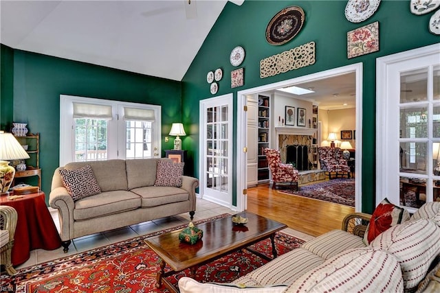 8265 Wrenfield Dr, Williamsburg, VA 23188 - tiled living area with a stone fireplace and high vaulted ceiling