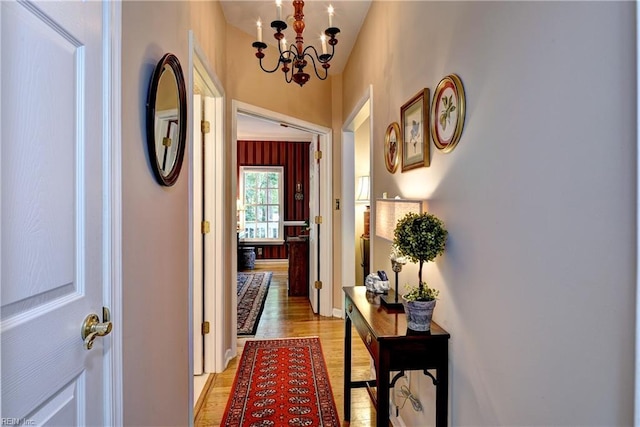 8265 Wrenfield Dr, Williamsburg, VA 23188 - hallway with a chandelier and light wood-style floors