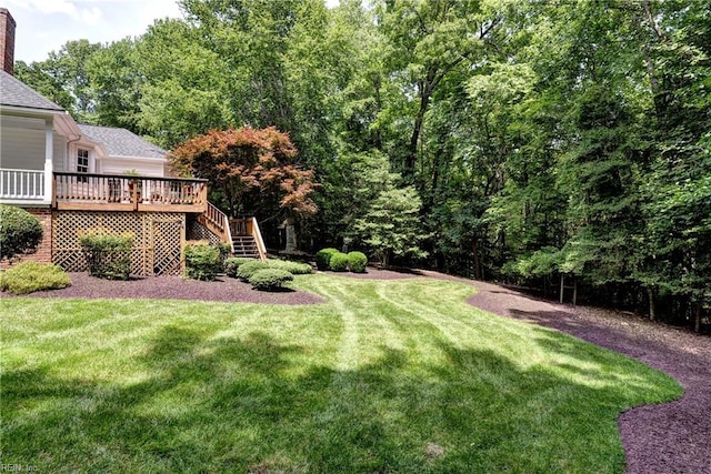 8265 Wrenfield Dr, Williamsburg, VA 23188 - view of green lawn featuring stairway, a deck, and a view of trees