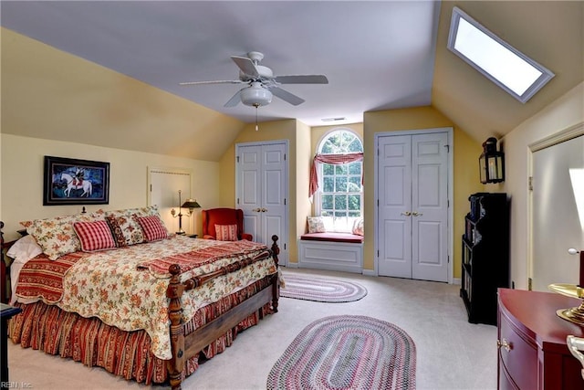 8265 Wrenfield Dr, Williamsburg, VA 23188 - bedroom featuring two closets, light carpet, vaulted ceiling, and ceiling fan