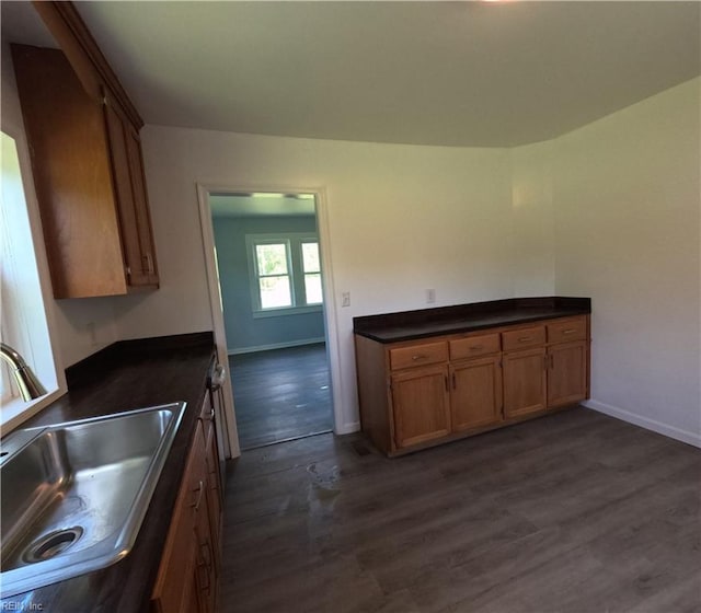 7276 Griffin Rd, Gloucester, VA 23061 - kitchen featuring dark countertops, dark wood-style flooring, and brown cabinetry