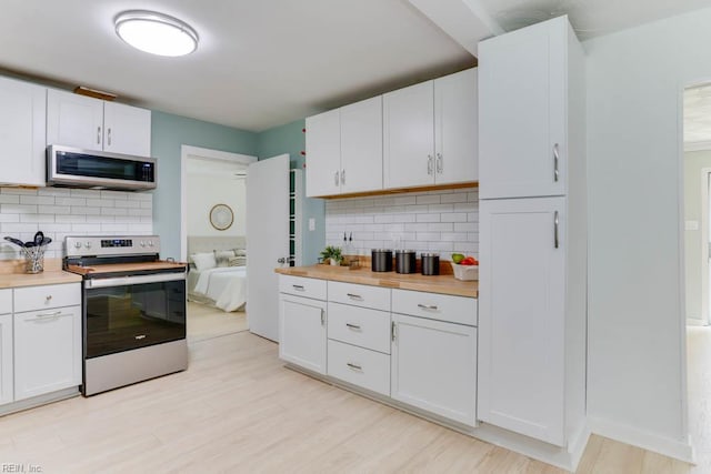 331 Silina Ct, Virginia Beach, VA 23452 - kitchen with stainless steel appliances, tasteful backsplash, light wood-type flooring, and white cabinetry