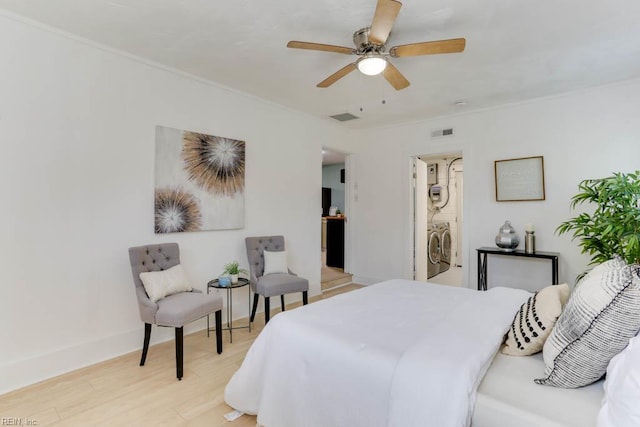 331 Silina Ct, Virginia Beach, VA 23452 - bedroom featuring stacked washer and clothes dryer, light wood-style floors, a ceiling fan, and ornamental molding