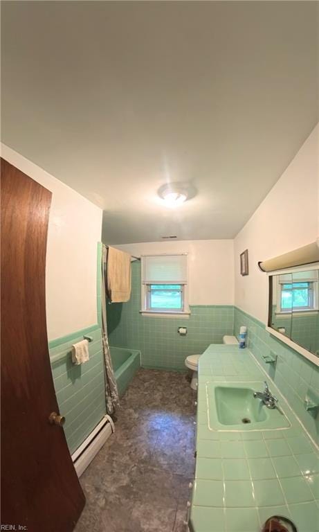3244 Pruden Blvd, Suffolk, VA 23434 - bathroom featuring a baseboard heating unit, tile walls, a bathtub, wainscoting, and vanity