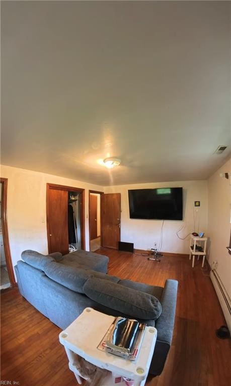 3244 Pruden Blvd, Suffolk, VA 23434 - living area with wood finished floors and a baseboard heating unit