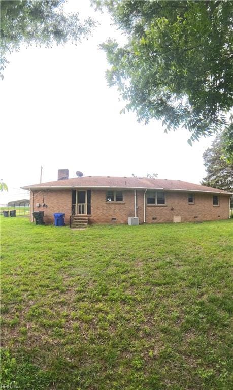3244 Pruden Blvd, Suffolk, VA 23434 - rear view of house featuring brick siding, a lawn, a chimney, crawl space, and entry steps