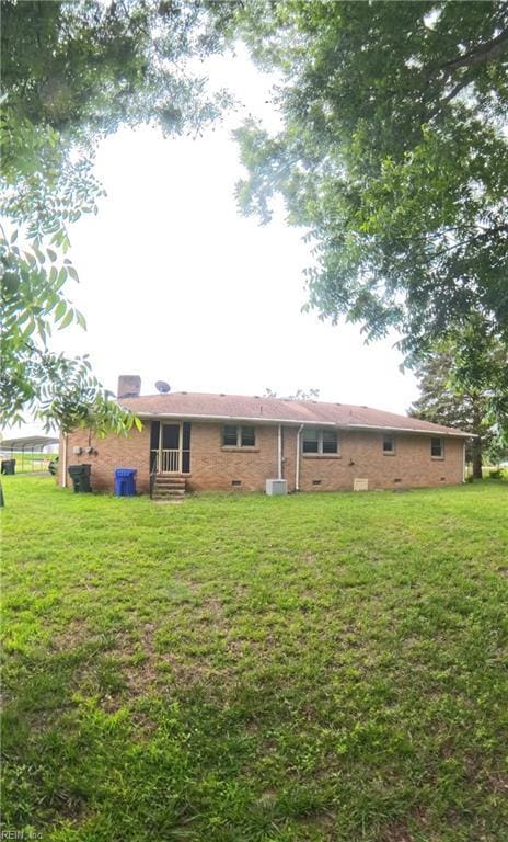 3244 Pruden Blvd, Suffolk, VA 23434 - rear view of property with entry steps, a lawn, and brick siding