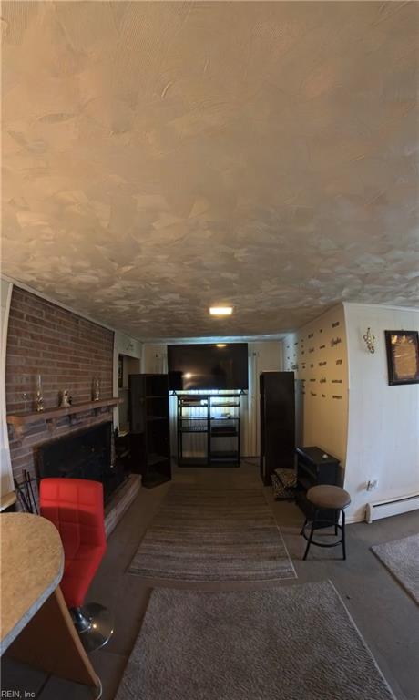 3244 Pruden Blvd, Suffolk, VA 23434 - living area featuring baseboard heating, a brick fireplace, and carpet flooring
