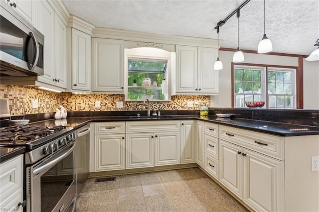102 Canvasback Trl, Newport News, VA 23602 - kitchen with appliances with stainless steel finishes, a textured ceiling, backsplash, granite tiled floors, and decorative light fixtures