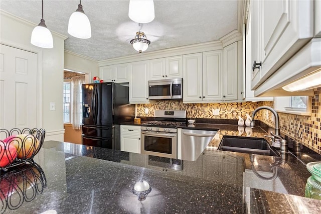 102 Canvasback Trl, Newport News, VA 23602 - kitchen with appliances with stainless steel finishes, white cabinetry, tasteful backsplash, pendant lighting, and crown molding