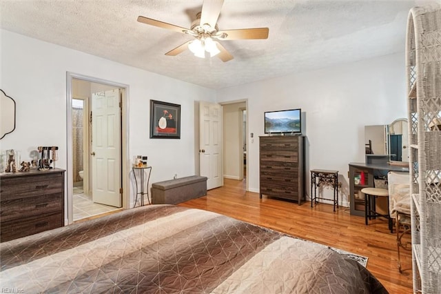 102 Canvasback Trl, Newport News, VA 23602 - bedroom with wood finished floors, a textured ceiling, connected bathroom, and a ceiling fan
