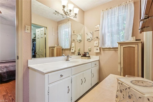 102 Canvasback Trl, Newport News, VA 23602 - bathroom featuring vanity, healthy amount of natural light, a chandelier, a textured ceiling, and ensuite bathroom