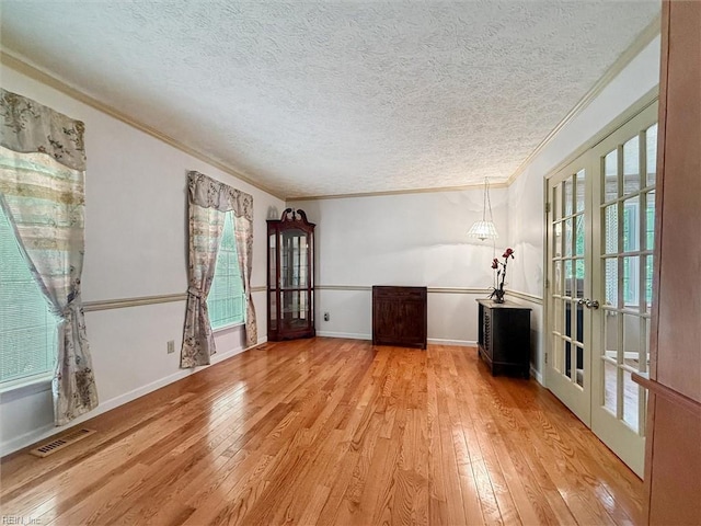 102 Canvasback Trl, Newport News, VA 23602 - spare room with french doors, light wood finished floors, a textured ceiling, and ornamental molding