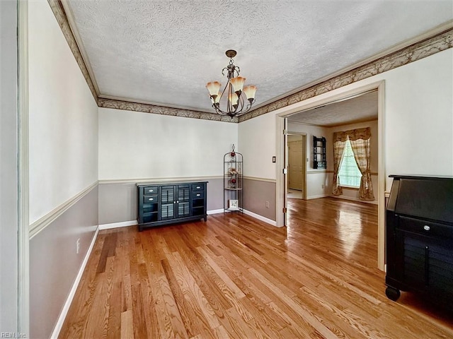 102 Canvasback Trl, Newport News, VA 23602 - unfurnished dining area featuring wood finished floors, a textured ceiling, a chandelier, and ornamental molding