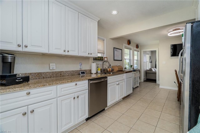 325 E Lorengo Ave, Norfolk, VA 23503 - kitchen with stainless steel appliances, light tile patterned floors, white cabinets, light stone counters, and recessed lighting