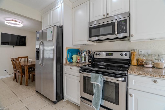 325 E Lorengo Ave, Norfolk, VA 23503 - kitchen with stainless steel appliances, light tile patterned floors, white cabinetry, and light stone countertops