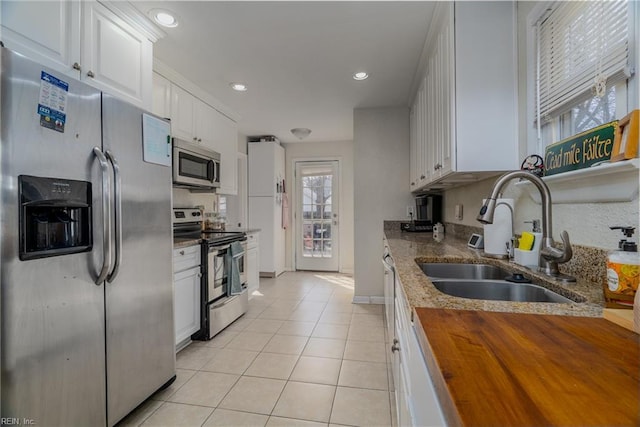 325 E Lorengo Ave, Norfolk, VA 23503 - kitchen featuring appliances with stainless steel finishes, wood counters, light tile patterned flooring, white cabinetry, and recessed lighting