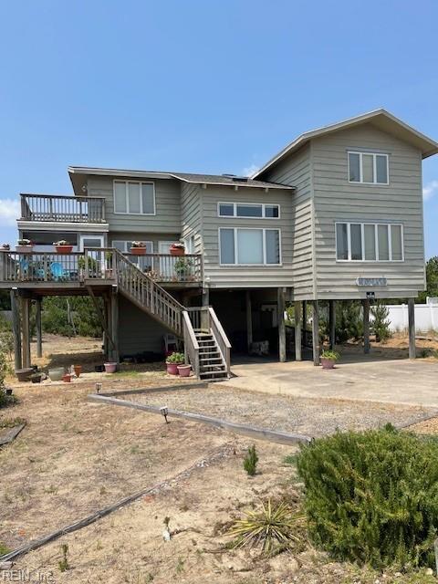 3225 Sandfiddler Rd, Virginia Beach, VA 23456 - rear view of house featuring a carport, stairs, a deck, and dirt driveway