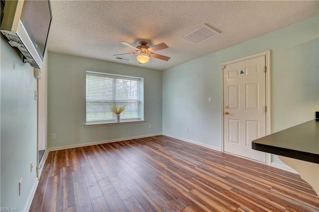 307 Melrose Ct, Suffolk, VA 23434 - empty room with a ceiling fan, wood finished floors, and a textured ceiling