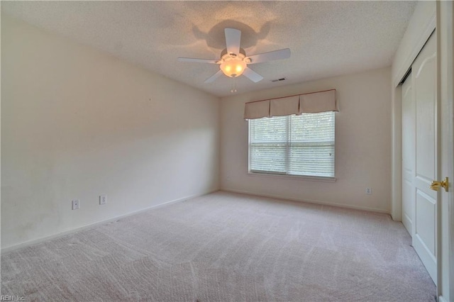 307 Melrose Ct, Suffolk, VA 23434 - empty room featuring light carpet, a ceiling fan, and a textured ceiling