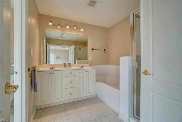 307 Melrose Ct, Suffolk, VA 23434 - full bathroom featuring a garden tub, tile patterned flooring, double vanity, and a stall shower