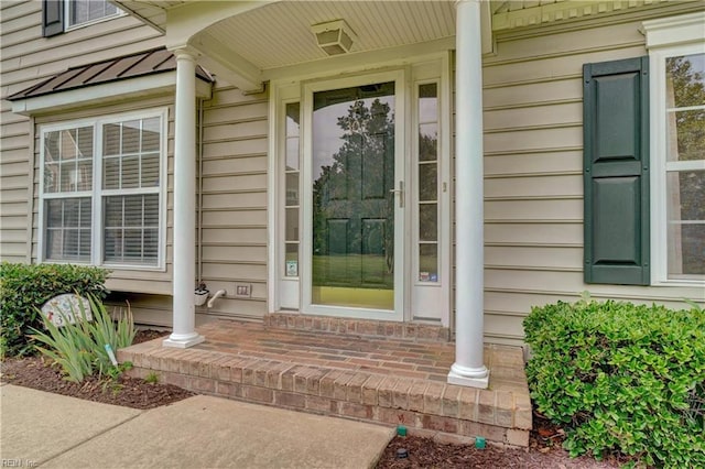 307 Melrose Ct, Suffolk, VA 23434 - doorway to property featuring a standing seam roof, a metal roof, and a porch