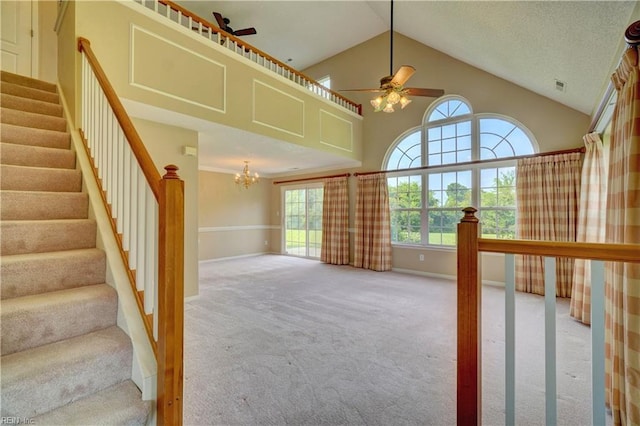 307 Melrose Ct, Suffolk, VA 23434 - unfurnished living room featuring carpet floors, a chandelier, a ceiling fan, stairs, and high vaulted ceiling