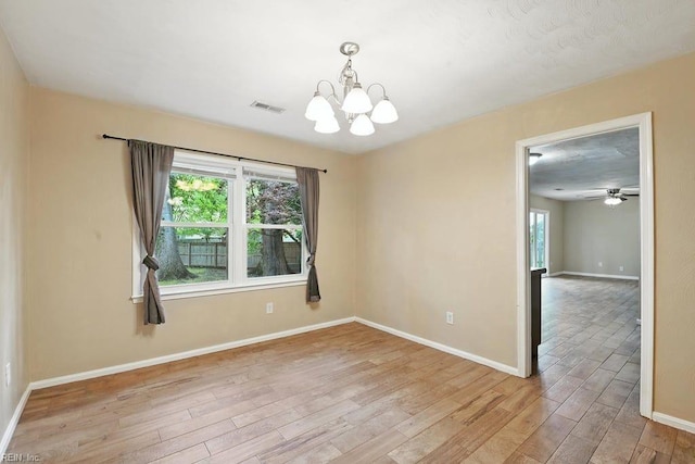 1027 E Little Back River Rd, Hampton, VA 23669 - spare room with light wood-style flooring, a chandelier, and a ceiling fan