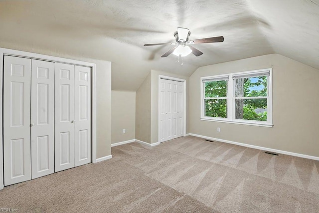 1027 E Little Back River Rd, Hampton, VA 23669 - unfurnished bedroom with multiple closets, carpet floors, vaulted ceiling, and a ceiling fan