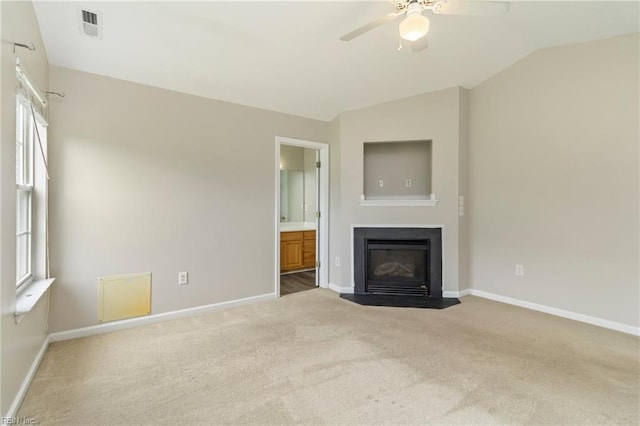 102 Sonoma Ct, Williamsburg, VA 23185 - unfurnished living room featuring carpet flooring, a ceiling fan, a fireplace with flush hearth, vaulted ceiling, and plenty of natural light