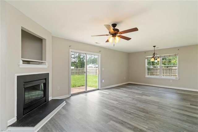 102 Sonoma Ct, Williamsburg, VA 23185 - unfurnished living room with wood finished floors, a glass covered fireplace, and a ceiling fan