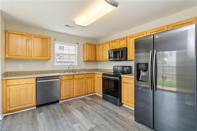 102 Sonoma Ct, Williamsburg, VA 23185 - kitchen featuring appliances with stainless steel finishes, light brown cabinetry, light countertops, and wood finished floors