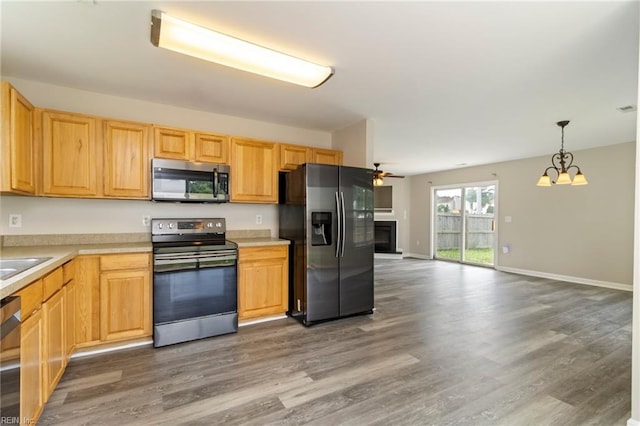 102 Sonoma Ct, Williamsburg, VA 23185 - kitchen featuring stainless steel appliances, a glass covered fireplace, wood finished floors, light countertops, and ceiling fan