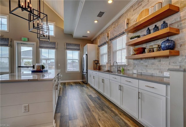 1928 Bexley Ln, Chesapeake, VA 23322 - kitchen with freestanding refrigerator, crown molding, dark wood-style flooring, white cabinetry, and open shelves