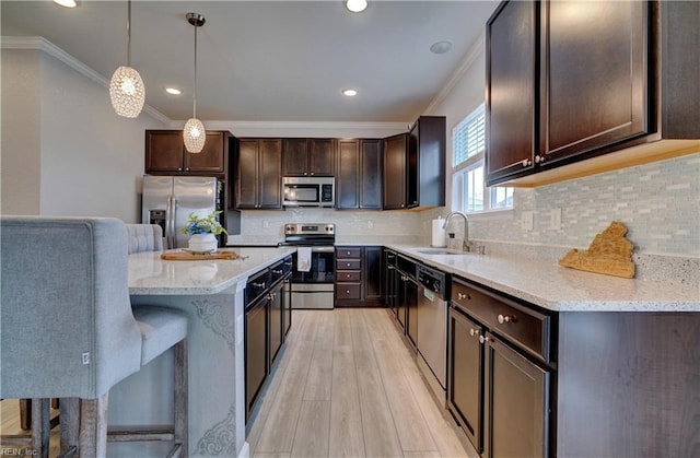 1928 Bexley Ln, Chesapeake, VA 23322 - kitchen with stainless steel appliances, crown molding, dark brown cabinets, light wood-style floors, and decorative light fixtures