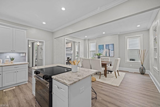 2233 Keller Ave, Norfolk, VA 23509 - kitchen featuring black electric range oven, light wood-style floors, recessed lighting, a center island, and crown molding