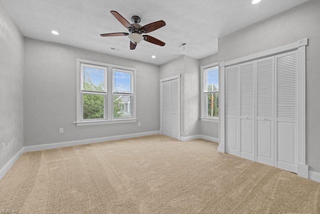 2233 Keller Ave, Norfolk, VA 23509 - unfurnished bedroom featuring multiple windows, carpet floors, two closets, recessed lighting, and a ceiling fan