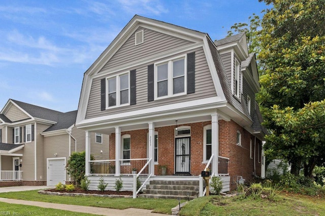 2233 Keller Ave, Norfolk, VA 23509 - colonial inspired home featuring a gambrel roof, a porch, brick siding, and driveway