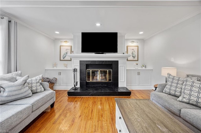 929 Magnolia Ave, Norfolk, VA 23508 - living room with light wood finished floors, crown molding, a tile fireplace, and recessed lighting