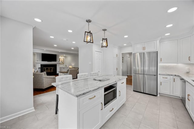 929 Magnolia Ave, Norfolk, VA 23508 - kitchen with appliances with stainless steel finishes, white cabinetry, recessed lighting, and light stone countertops
