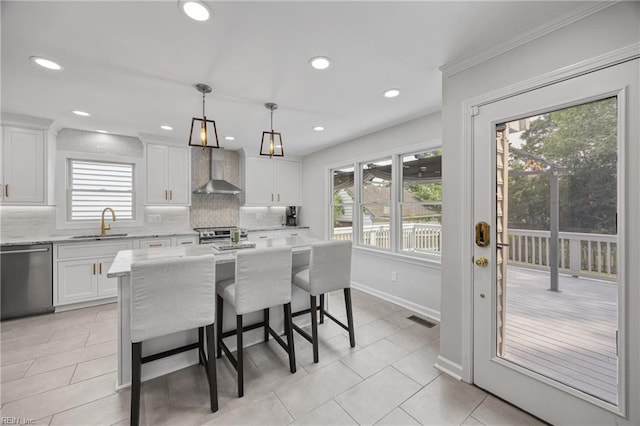 929 Magnolia Ave, Norfolk, VA 23508 - kitchen featuring stainless steel dishwasher, wall chimney exhaust hood, plenty of natural light, tasteful backsplash, and recessed lighting