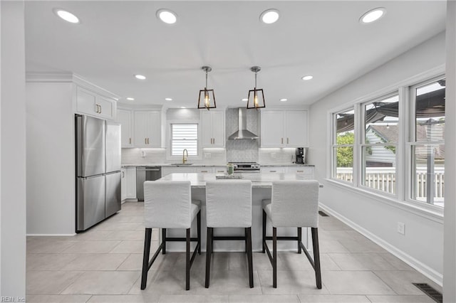 929 Magnolia Ave, Norfolk, VA 23508 - kitchen featuring appliances with stainless steel finishes, wall chimney exhaust hood, healthy amount of natural light, decorative backsplash, and recessed lighting
