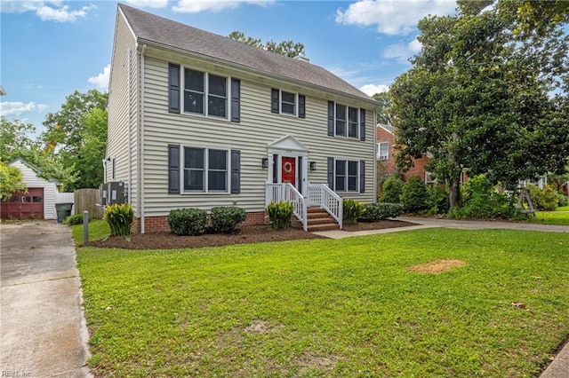 929 Magnolia Ave, Norfolk, VA 23508 - colonial house featuring a front lawn, driveway, and an outdoor structure