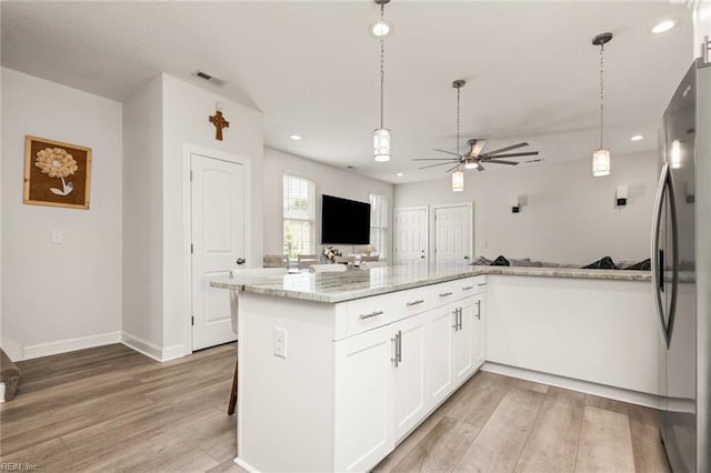 401 W 30th St, Norfolk, VA 23508 - kitchen with freestanding refrigerator, light wood-type flooring, ceiling fan, open floor plan, and white cabinetry