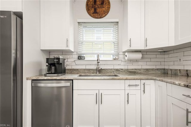 401 W 30th St, Norfolk, VA 23508 - kitchen featuring appliances with stainless steel finishes, white cabinetry, tasteful backsplash, and light stone countertops