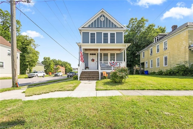 401 W 30th St, Norfolk, VA 23508 - view of front of house featuring covered porch, a front lawn, and board and batten siding