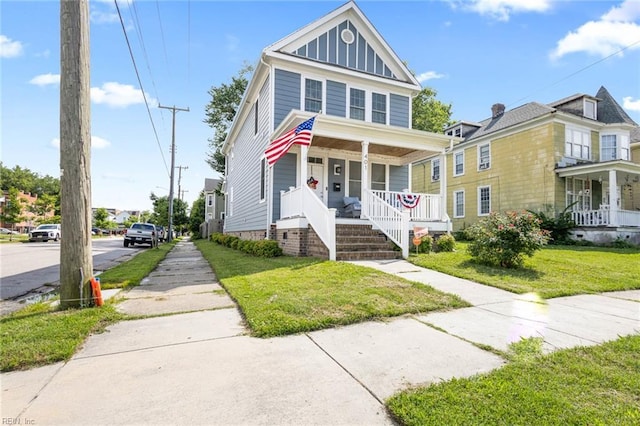 401 W 30th St, Norfolk, VA 23508 - american foursquare style home featuring covered porch, board and batten siding, and a front yard